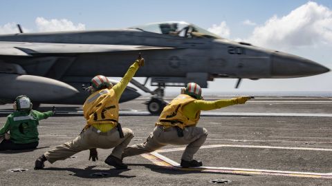 Sailors signal an F/A-18E Super Hornet to launch from the flight deck of the USS Ronald Reagan during flight operations in the Indian Ocean. 