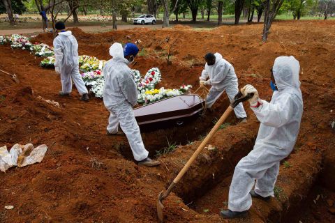 Cemetery workers bury coronavirus victim Elisa Moreira de Araujo at the Vila Formosa cemetery in Sao Paulo, Brazil, on Thursday, July 16. She was 79.