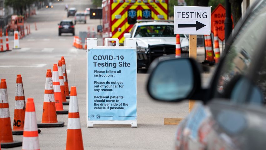 Cars wait in line at a drive up COVID-19 testing site inside the American Airlines Center parking garage in Dallas on June 27, 2020.