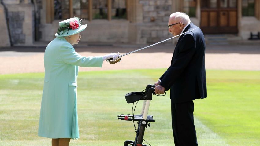 WINDSOR, ENGLAND - JULY 17: Queen Elizabeth II awards Captain Sir Thomas Moore with the insignia of Knight Bachelor at Windsor Castle on July 17, 2020 in Windsor, England. British World War II veteran Captain Tom Moore raised over £32 million for the NHS during the coronavirus pandemic.  (Photo by Chris Jackson/Getty Images)