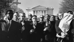 UNITED STATES - FEBRUARY 07:  "Leaders of the protest, holding flags, from left Bishop James Shannon, Rabbi Abraham Heschel, Dr. Martin Luther King and Rabbi Maurice Eisendrath." Tomb of the Unknown Soldier, Arlington Cemetery, February 6, 1968. Published February 7, 1968.  (Photo by Charles Del Vecchio/The Washington Post via Getty Images)