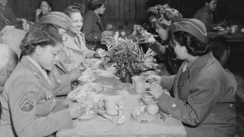 The women of the 6888th eat at a mess table in England. 