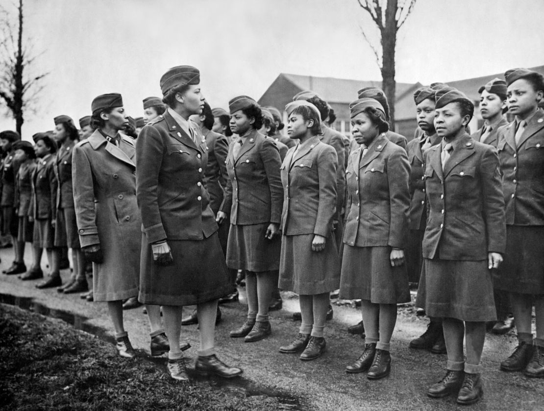 A Women's Army Corps major inspects newly arrived Black troops at a temporary post in England in February 1945. Willie Belle Irvin is at the far right.