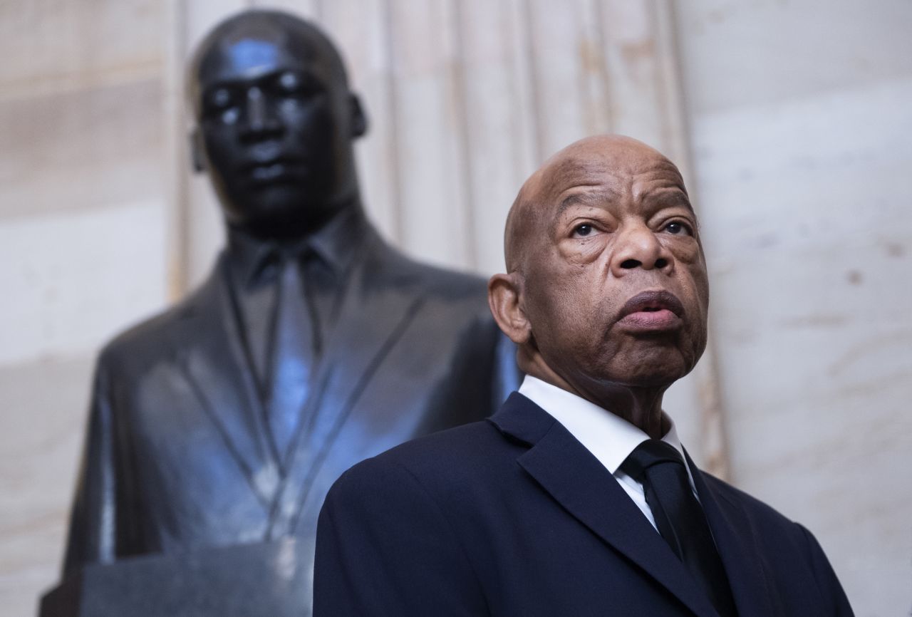 Lewis is seen near a statue of Martin Luther King Jr. in the US Capitol rotunda.