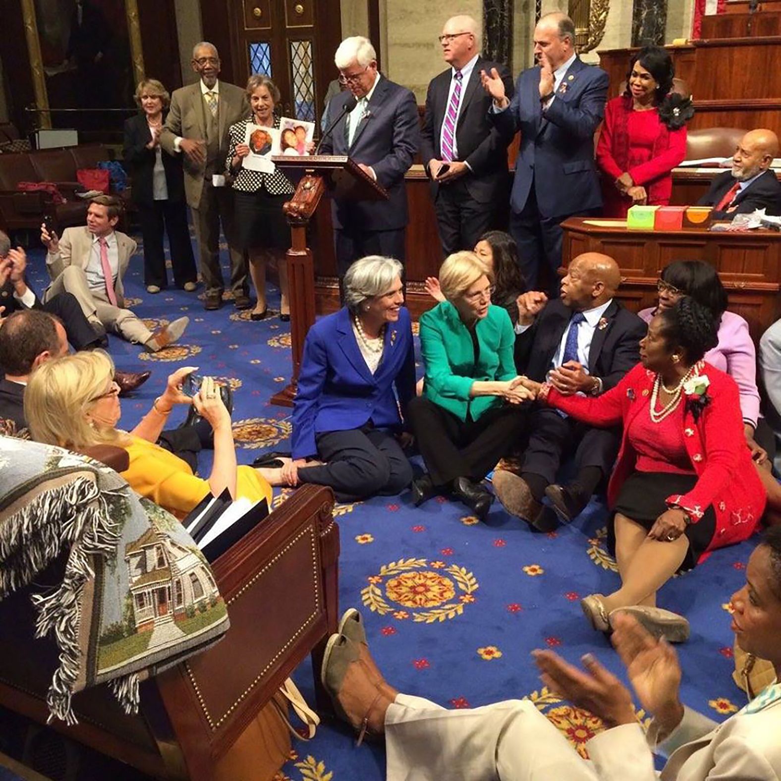 Lewis sits with other Democrats on the House floor as they try to force a vote on gun control measures in June 2016. Lewis launched the sit-in protest in the wake of the Orlando nightclub shooting, which at the time was the deadliest mass shooting in US history.