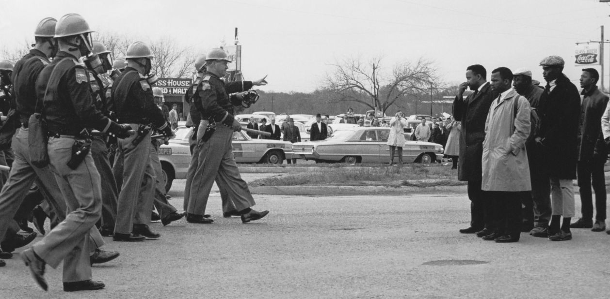 Lewis, Williams and other marchers face a line of state troopers blocking the Edmund Pettus Bridge.