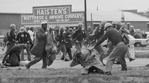 John Lewis is beaten by a state trooper during a civil rights voting march in Selma, Ala., on March 7, 1965. 