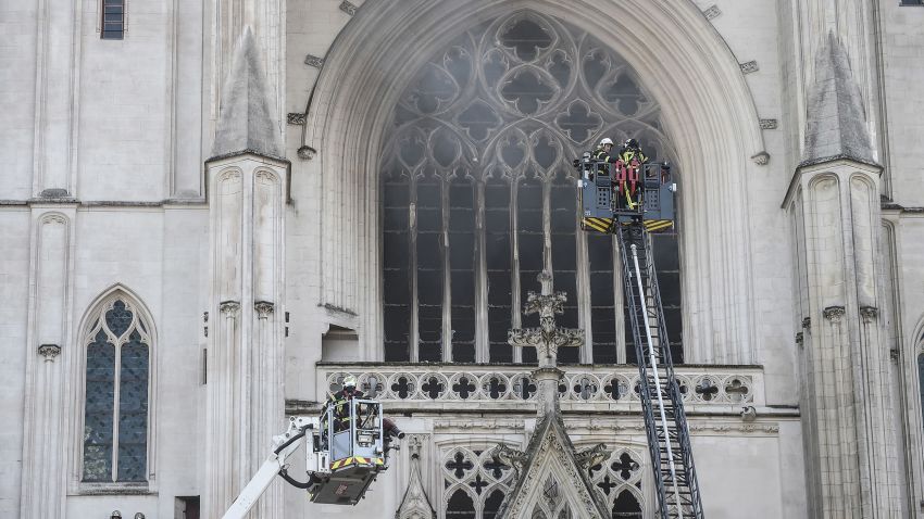Firefighters are at work to put out a fire at the Saint-Pierre-et-Saint-Paul cathedral in Nantes, France, on July 18, 2020. - The major fire that broke out on July 18, 2020 inside the cathedral in the western French city of Nantes has now been contained, emergency services said. It is a major fire," the emergency operations centre said, adding that crews were alerted just before 08:00 am (0600 GMT) and that 60 firefighters had been dispatched. (Photo by Sebastien Salom-Gomis/AFP/Getty Images)