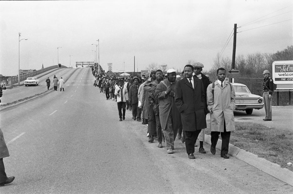 Lewis, in the light coat, marches beside Hosea Williams as they lead other civil rights activists in the first march from Selma to Montgomery, protesting the lack of voting rights for Black citizens, on March 7, 1965. That day the march was violently ended by Alabama state troopers, an incident that is now known as "Bloody Sunday."