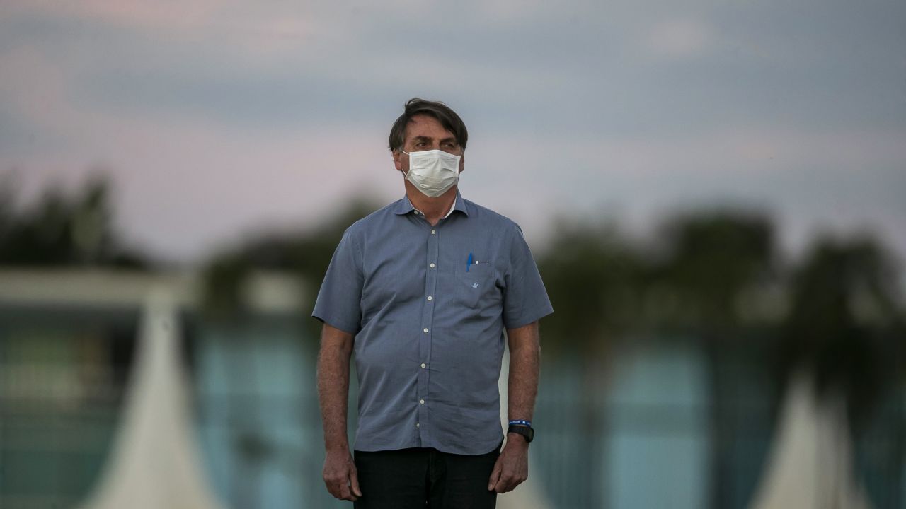 Brazilian President Jair Bolsonaro stands in front of the Alvorada Palace in Brasilia, where he has been in quarantine since testing positive for coronavirus.