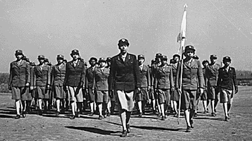 WAAC Capt. Charity Adams of Columbia, SC, who was commissioned from the first officer candidate class, and the first of her group to receive a commission, drills her company on the drill ground at the first WAAC Training Center, Fort Des Moines, Iowa.