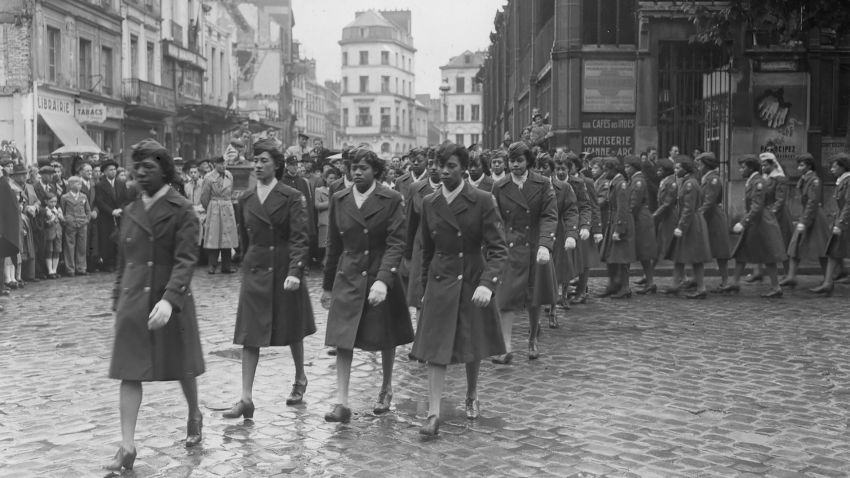 Original Caption: "General view of parade which followed ceremony in honor of Jean D'Arc, at the market place where she was burned at the stake. It was the negro WAC battalion's first parade on the continent. Rouen, France." Original Signal Corps Numbers: ETO-HQ-45-28912. Photographer: Pfc. Stedman