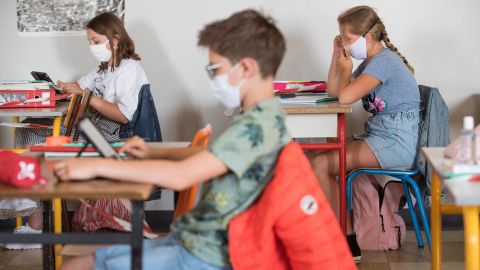 Pupils wearing fabric masks listen to their teacher in a school in Beaucamps-Ligny, near Lille, France. Masks are now compulsory in all enclosed spaces there.