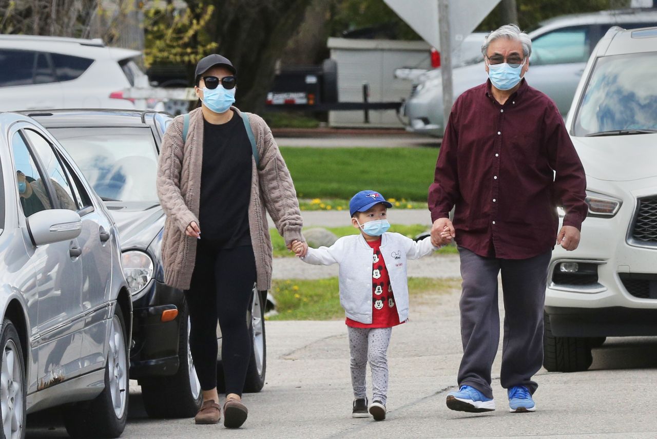<strong>Canada: A f</strong>amily wear face masks as they walk in Richmond Hill, Ontario, on May 16.