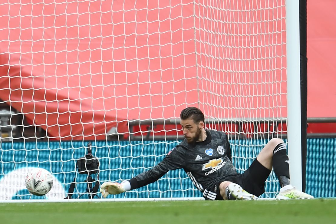 Manchester United goalkeeper David de Gea is unable to prevent a shot from Chelsea's French striker Olivier Giroud beating him to give Chelsea the lead during the English FA Cup semi-final at Wembley.