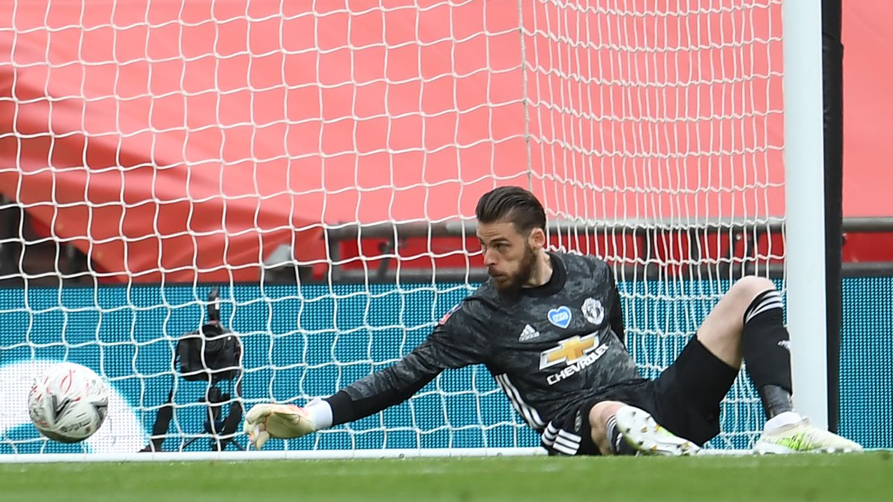 Manchester United goalkeeper David de Gea is unable to prevent a shot from Chelsea's French striker Olivier Giroud beating him to give Chelsea the lead during the English FA Cup semi-final at Wembley.