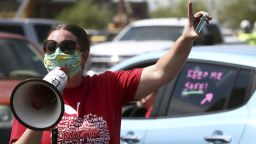 Local teacher Lisa Vaaler joins other teachers as they hold a #Return2SchoolSafely Motor March protest on Wednesday, July 15, 2020, in Phoenix, Arizona. Several Arizona teachers voiced fears about returning to school in a state that continues to be ravaged by the coronavirus. (AP Photo/Ross D. Franklin)