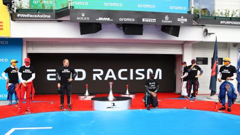 Lewis Hamilton takes a knee in support of the Black Lives Matter movement.