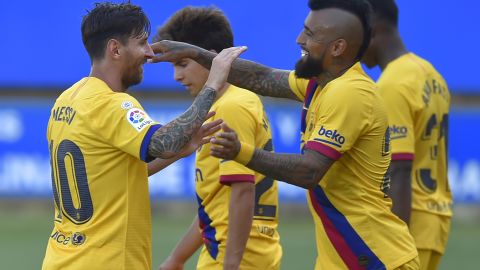 Messi (L) celebrates his second goal with teammates.