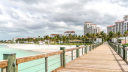 The boardwalk and beach area of a hotel temporarily closed stands empty in Nassau, Bahamas, on Friday, April 24. 