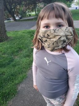 Emmy Ranno, 7, wears her mask. 