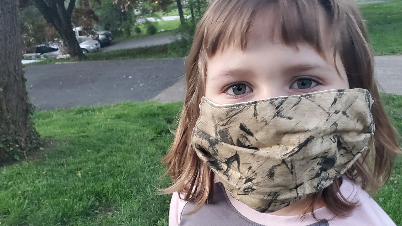Emmy Ranno, 7, wears her mask. 