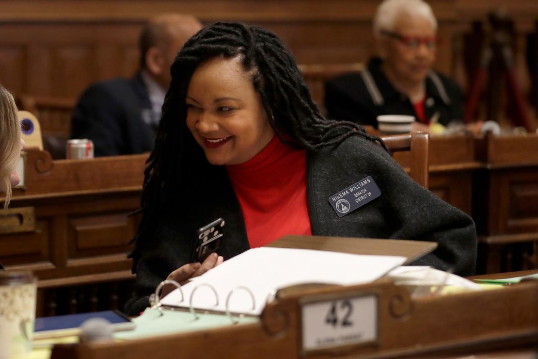 State Sen. Nikema Williams, an Atlanta area Democrat, talks to a colleague on the floor of the Georgia State Senate in February.