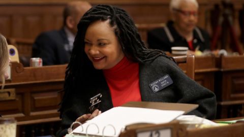 State Sen. Nikema Williams, an Atlanta area Democrat, talks to a colleague on the floor of the Georgia State Senate in February.