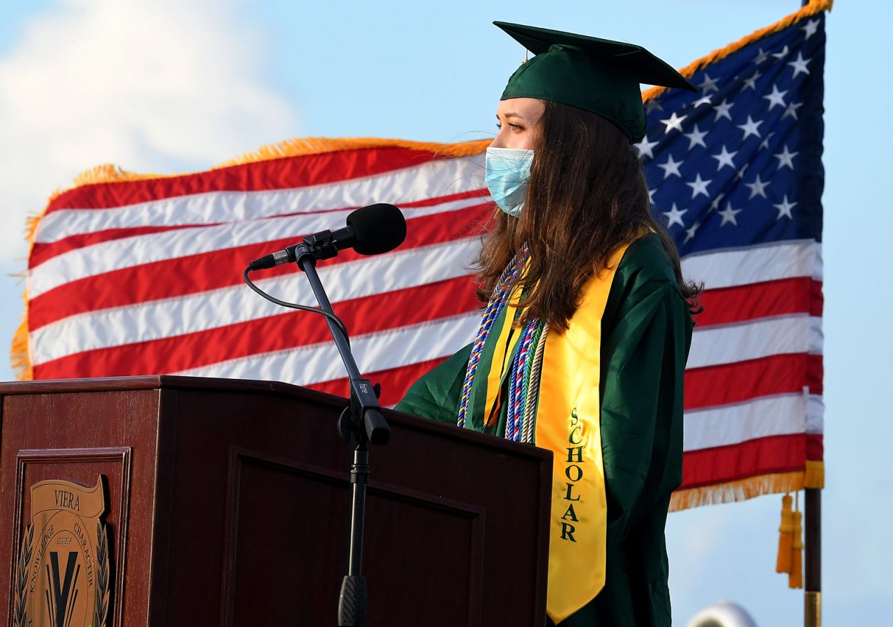 Taylor Calloway, a Principal's Scholar, wears a mask as she speaks at the Viera High School graduation ceremony in Brevard, Florida, on July 18.
