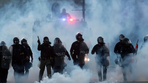 Police officers launch tear gas canisters at protesters in Detroit during a demonstration over the death of George Floyd in Minneapolis on Sunday, May 31, 2020.