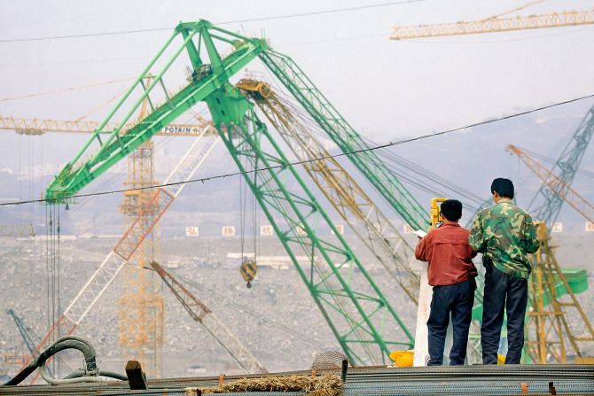 Surveyors work during the construction of the Three Gorges Dam on March 25, 2003.