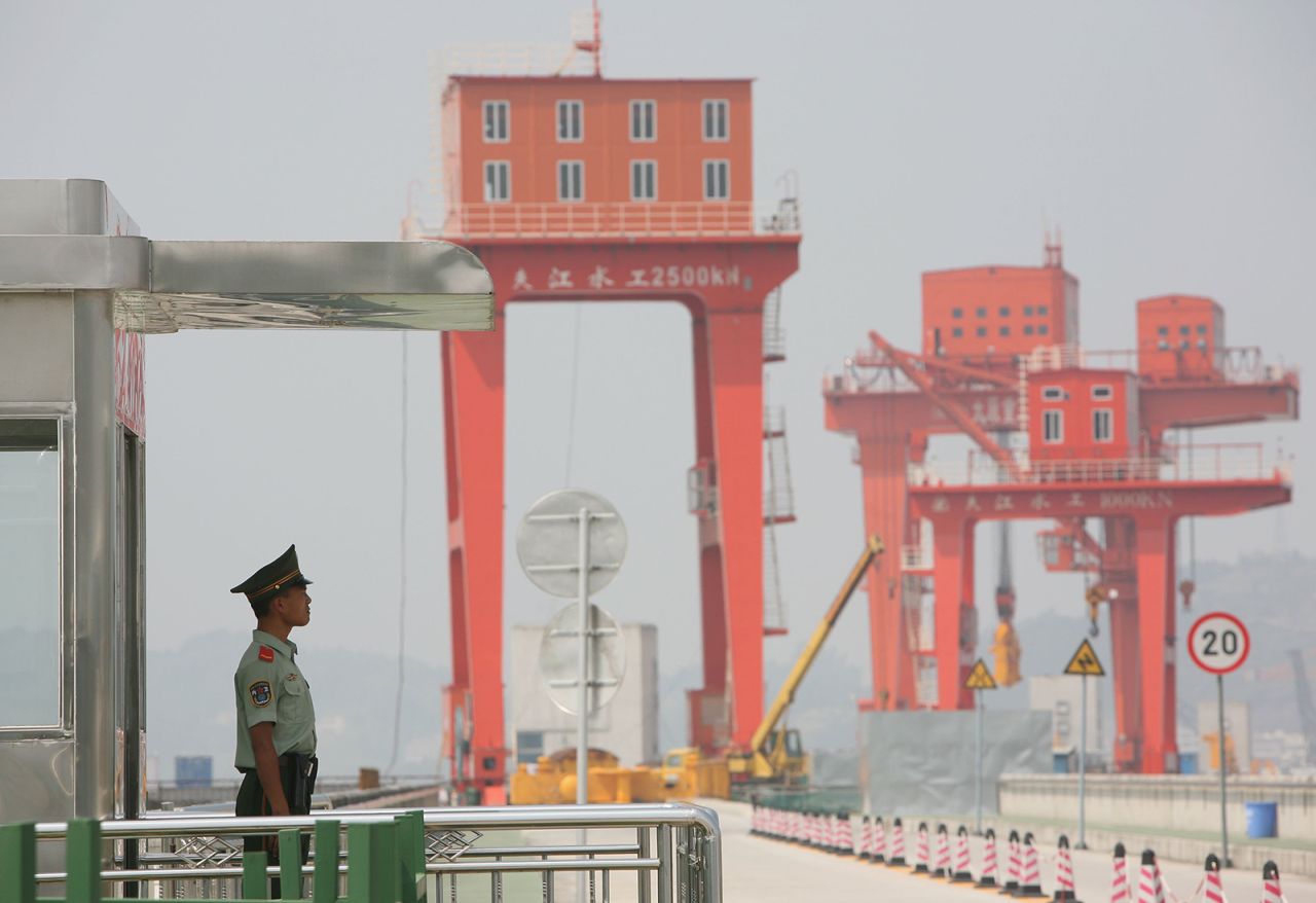 A policeman guards the top of the Three Gorges Dam on June 25, 2006.