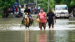 July 14, 2020, Kamrup, Assam, India: Villager walking wade through flood water on a street, in a flood effected village, in Kamrup district of Assam (Credit Image: © David Talukdar/ZUMA Wire)