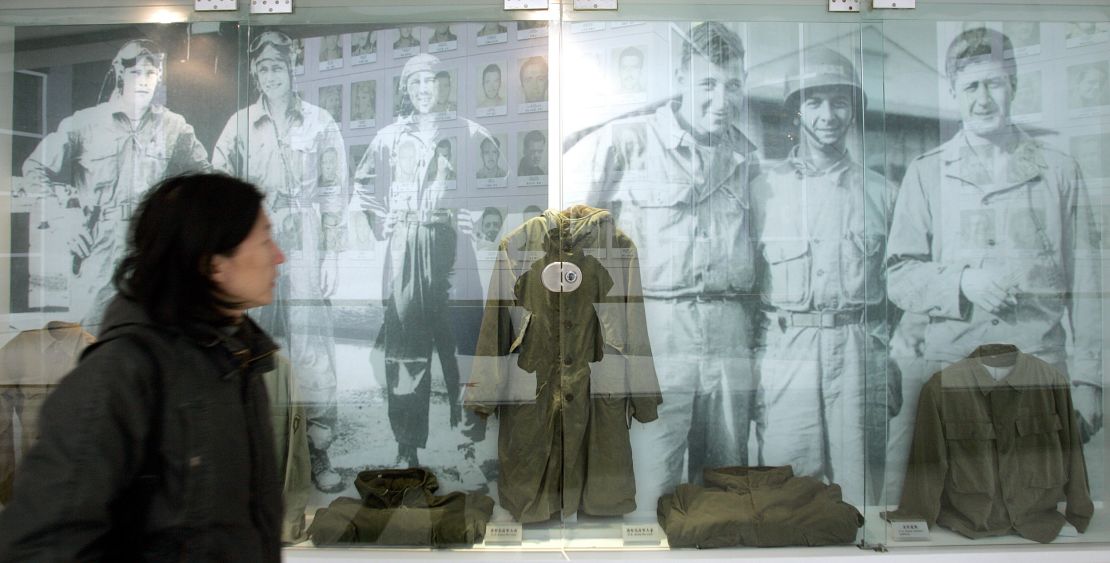 A visitor walks past images and old uniforms of the Flying Tigers at the Anti-Japanese War Museum in Dayi county in China's Sichuan province in 2005.