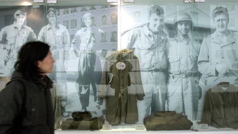 A visitor walks past images and old uniforms of the Flying Tigers at the Anti-Japanese War Museum in Dayi county in China's Sichuan province in 2005.