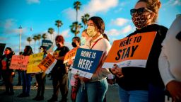 People hold signs during a rally in support of the Supreme Court's ruling in favor of the Deferred Action for Childhood Arrivals (DACA) program, in San Diego, California on June 18. 