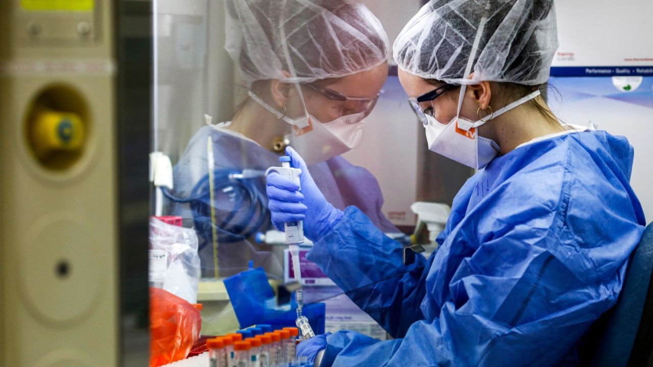 A medical worker tests samples of suspected COVID-19 coronavirus cases at the Maccabi Health Services laboratory in Israel's central city of Rehovot on May 27, 2020. - Israeli HMO Maccabi operates one of the biggest automated medical labs in the world that performs several thousand tests per day, where numerous and diverse tests are performed with no human intervention. Results are transferred directly to the referring physician's computer and recorded in each member's computerised medical record, usually in less than 24 hours. (Photo by GIL COHEN-MAGEN / AFP) (Photo by GIL COHEN-MAGEN/AFP via Getty Images)