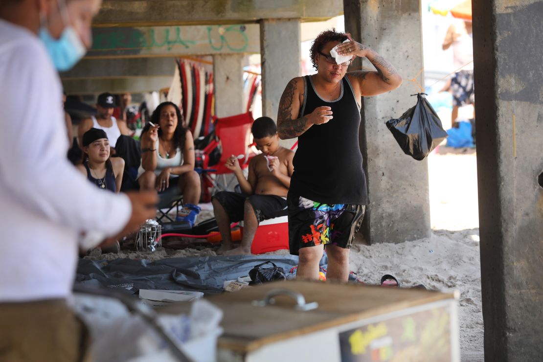 People try to keep cool at a crowded beach at Coney Island in Brooklyn on July 19, 2020 in New York City. Much of the country will experience another heat wave this weekend.