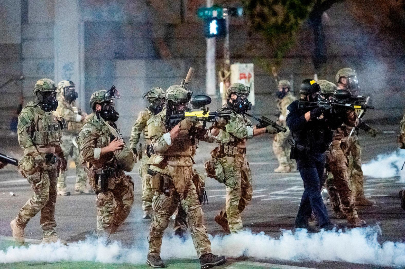 Federal agents use crowd-control munitions to disperse protesters at the courthouse on July 20. Officers used tear gas and projectiles to move the crowd after some protesters tore down a fence fronting the courthouse.