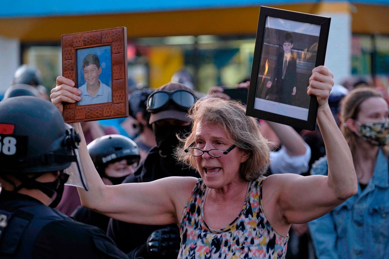 The mother of injured protester Donovan LaBella, who was shot in the head with an impact munition by federal officers, pleads with police during a protest outside the Portland Police Association building on July 13.