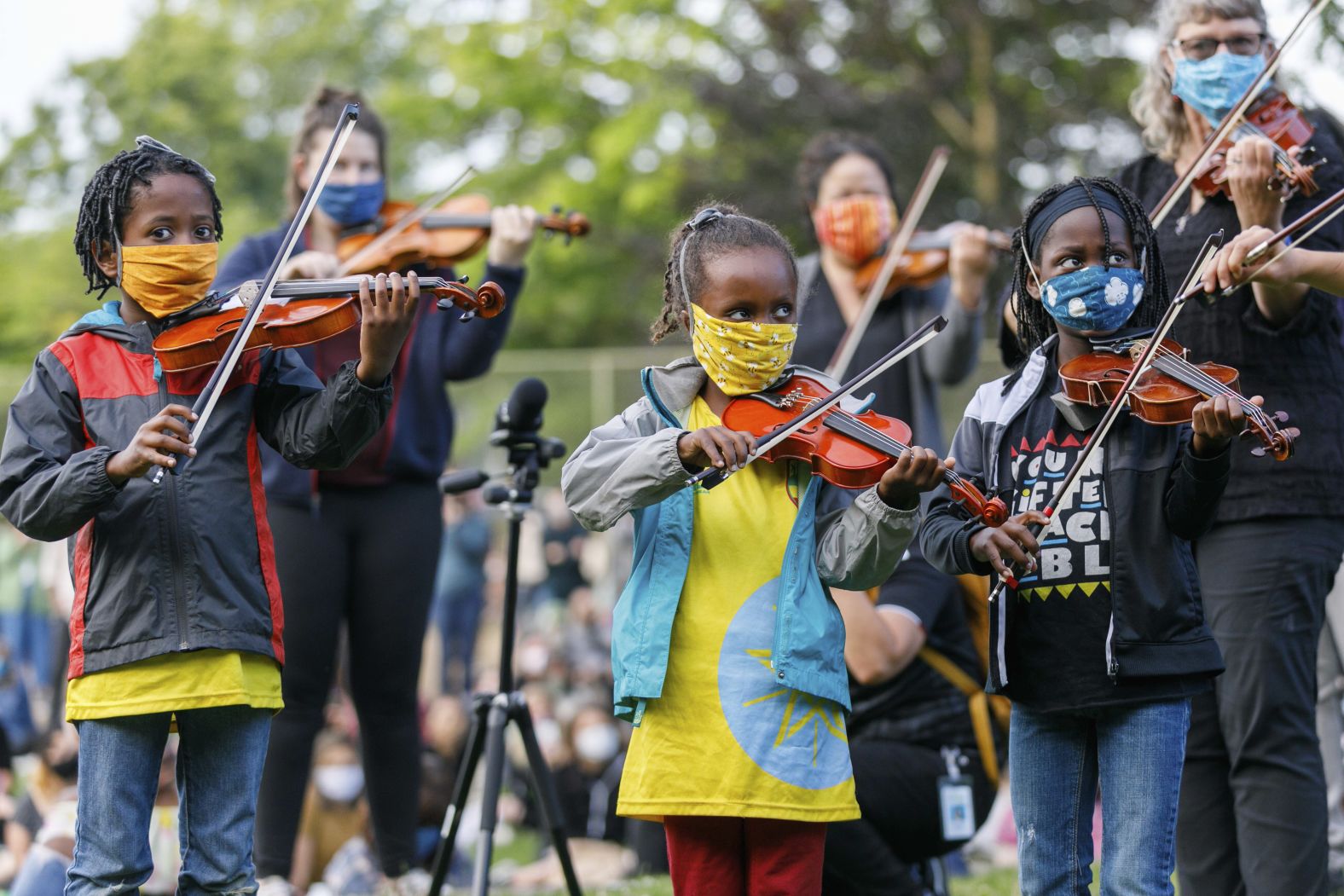 People play instruments on July 3 as they mourn the death of Elijah McClain, a 23-year-old Black man <a  target="_blank">who was killed by police in Colorado</a> last year.