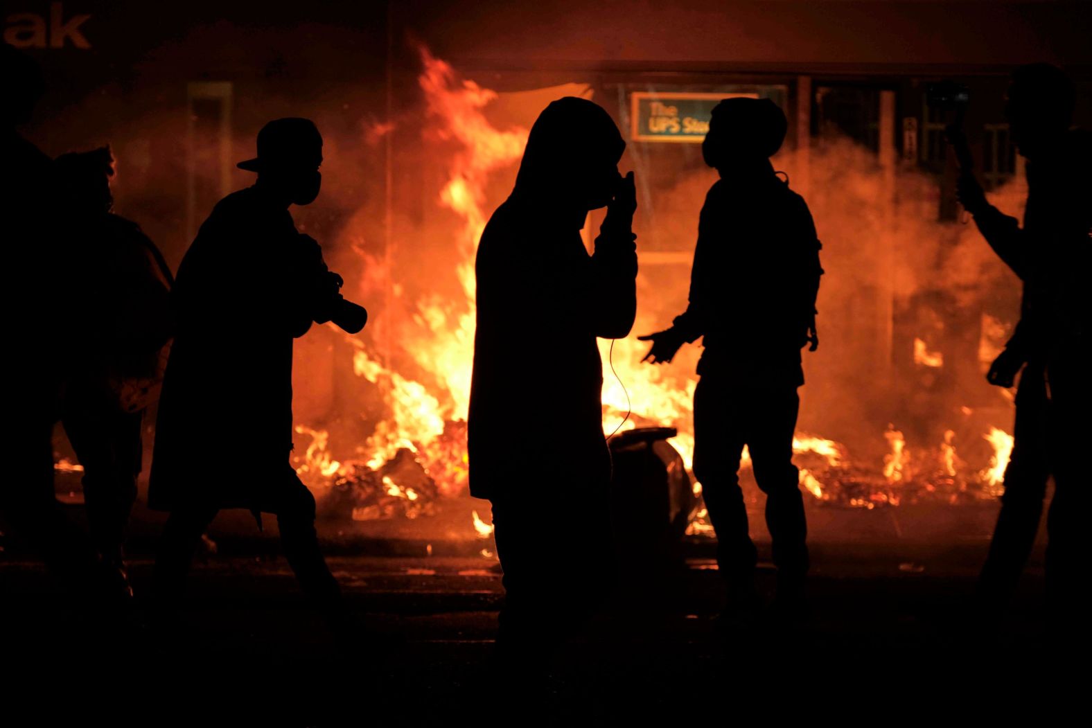 Trash cans burn during demonstrations on June 15.