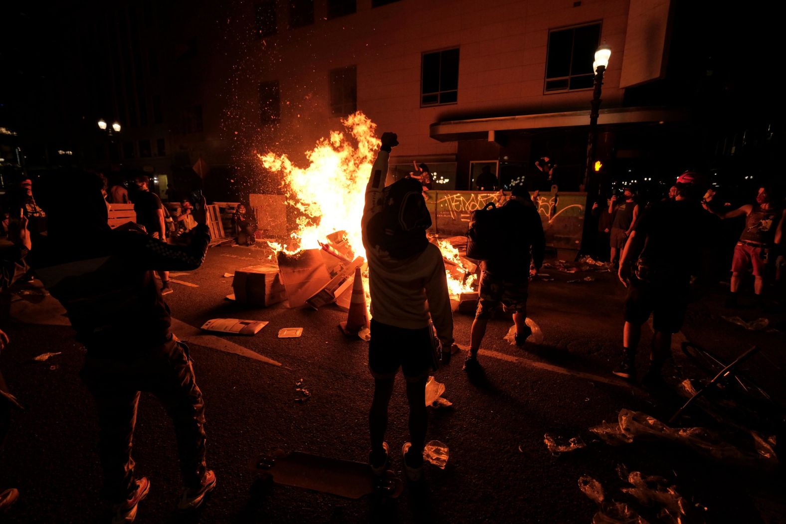 Protesters start a fire in the street on May 29.