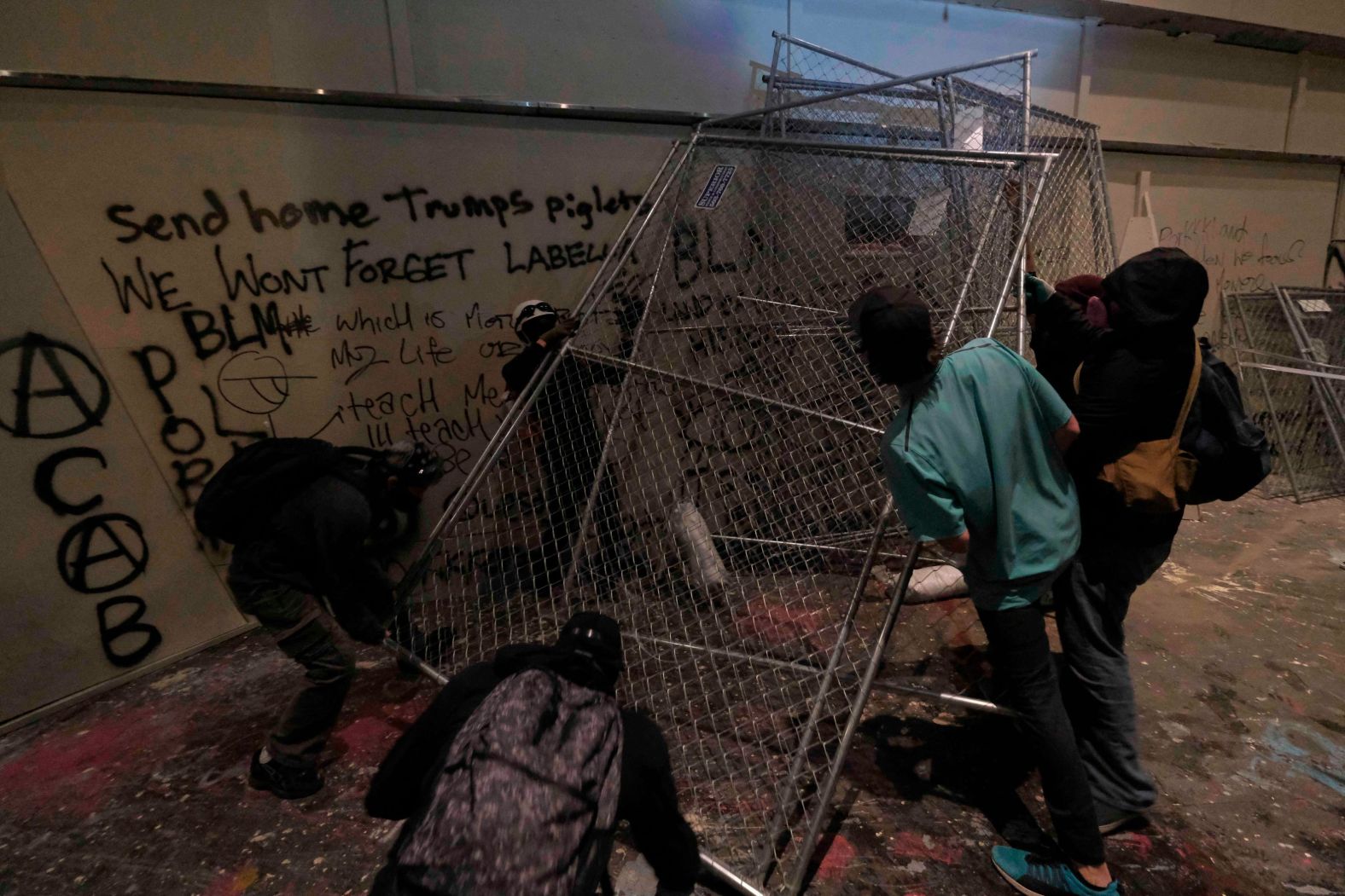 Protesters move fencing in front of a federal courthouse on July 18.