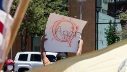 EL PASO, TX - APRIL 25: A protestor holds a  sign referencing the QAnon conspiracy theory outside the El Paso County Court House during a rally calling for the reopening of El Paso and Texas on April 25, 2020 in El Paso, Texas. Governor Greg Abbott has said he is consulting with medical professionals to create a plan to safely reopen the Texas and is expected to make an announcement in the coming days. (Photo by Cengiz Yar/Getty Images)