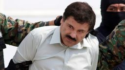 In this Feb. 22, 2014 file photo, Joaquin "El Chapo" Guzman, the head of Mexico's Sinaloa Cartel, is escorted to a helicopter in Mexico City following his capture in the beach resort town of Mazatlan, Mexico. 