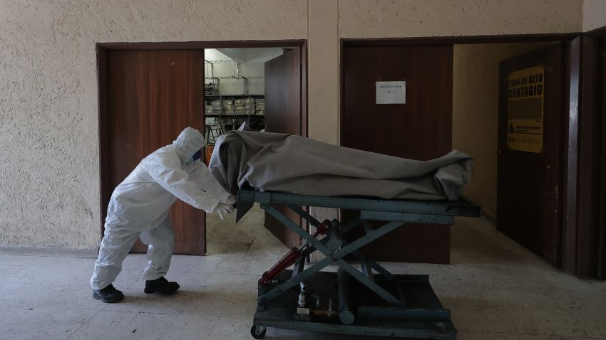 MEXICO CITY, MEXICO - JULY 15: (EDITORS NOTE: Image depicts death.) A crematorium worker takes the body of a person who died from COVID-19 to the ovens to be cremated at the San Isidro Crematorium in Azcapotzalco on July 15, 2020 in Mexico City, Mexico. The crematorium is receiving 20 corpses a day, when before the pandemic received an average of five. Mexican Health Secretary announced the country has over 36,000 victims from COVID-19, surpassing Italy but behind US, Brazil and UK. According to Johns Hopkins University, Mexico has registered 311,486 positive cases. Critics say Government started reopening economy too soon and this would increase number of victims. At the beginning of the pandemic, President Lopez Obrador had been accused of downplaying the effects of the virus to protect economic activity. (Photo by Hector Vivas/Getty Images)