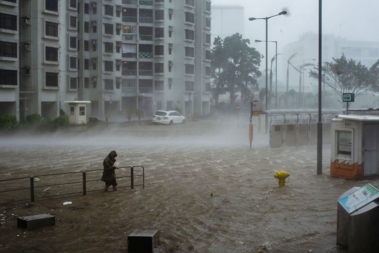 A man wades across the flood in Heng Fa Chuen during the approach of super Typhoon Mangkhut to Hong Kong on September 16, 2018.