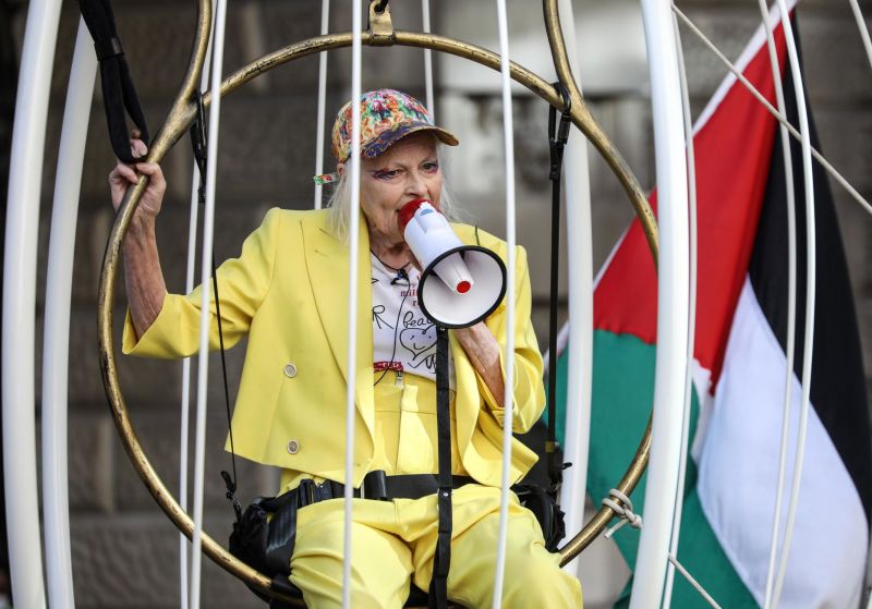 Vivienne Westwood suspends from birdcage to protest Assange