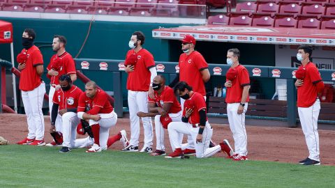 Cincinnati Reds players Phillip Ervin #6, Joey Votto #19, Amir Garrett #50 and Alex Blandino #0 kneel during the National Anthem prior to an exhibition game against the Detroit Tigers at Great American Ball Park on July 21, 2020 in Cincinnati, Ohio. 